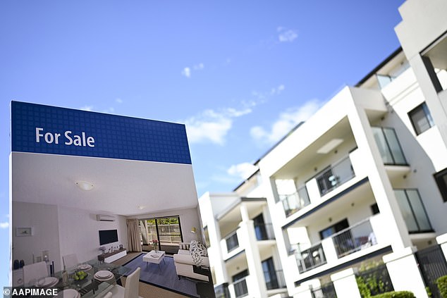 The best time to start saving for your own home is right now according to property experts. Pictured: A real estate advertising board is seen next to a newly built unit in Canberra