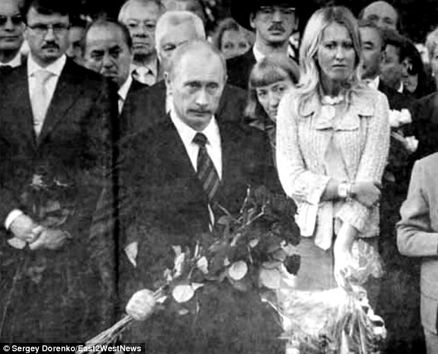 The television presenter and opposition figure (right) has known Vladimir Putin (centre holding flowers) since a child as her father Anatoly Sobchak was his political mentor and law professor. They are pictured together at Mr Sobchak