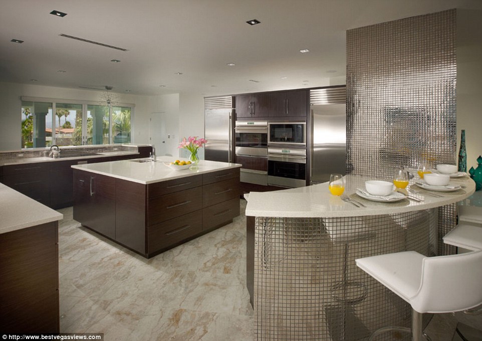 The kitchen features top-of-the-range double convection ovens and two Sub-Zero fridge freezers
